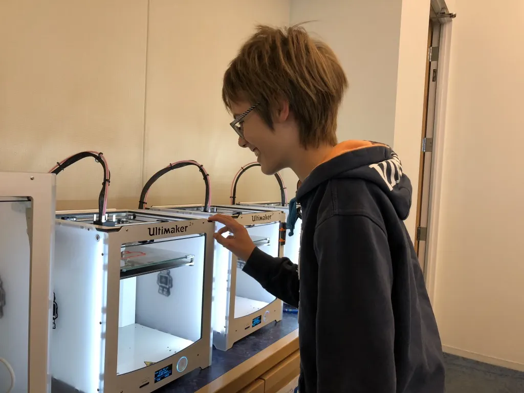 One of my team members overlooking the final model being printed on a 3D printer